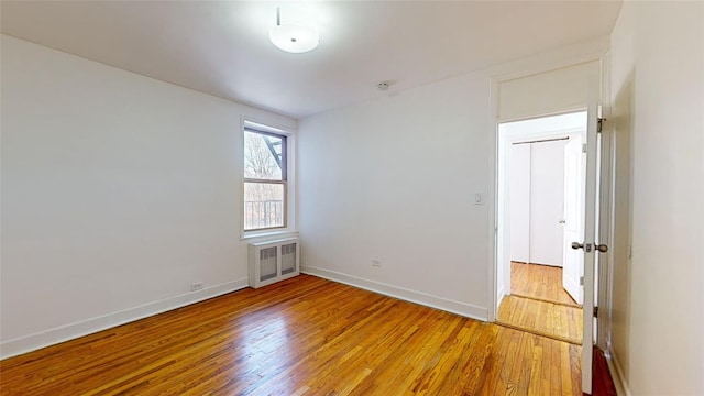 spare room featuring wood-type flooring