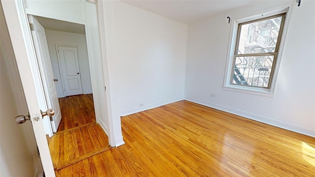 empty room with hardwood / wood-style flooring