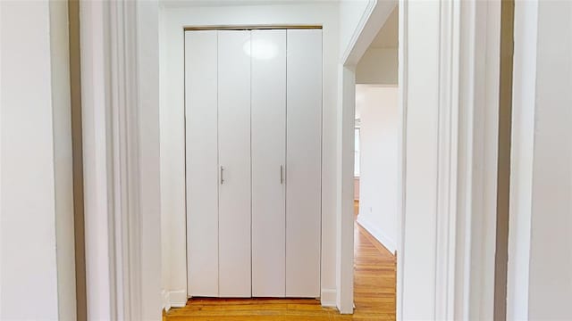 hallway with light hardwood / wood-style flooring