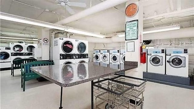 laundry room featuring stacked washer / drying machine and washer and clothes dryer