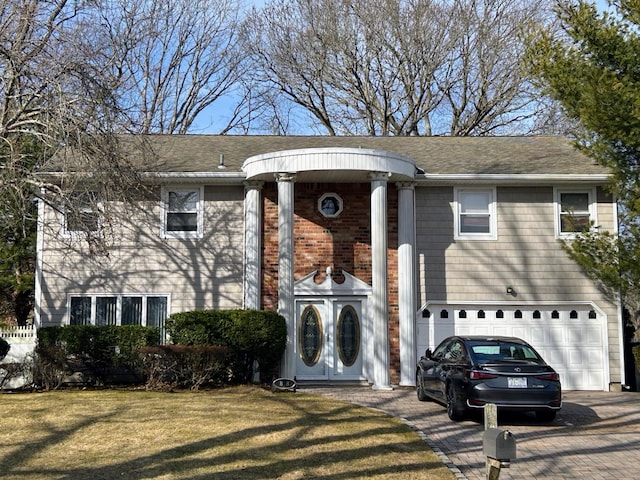 view of front facade with a garage and a front lawn