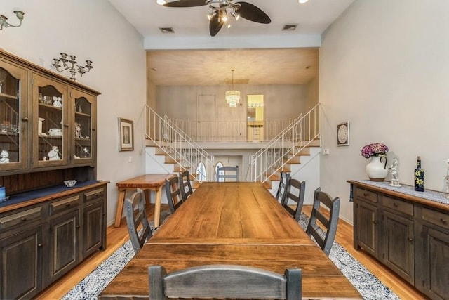 dining area with ceiling fan and light hardwood / wood-style flooring