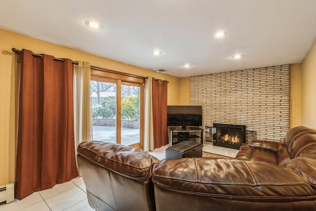 living room with baseboard heating and a fireplace