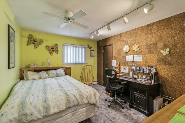 carpeted bedroom with ceiling fan and track lighting