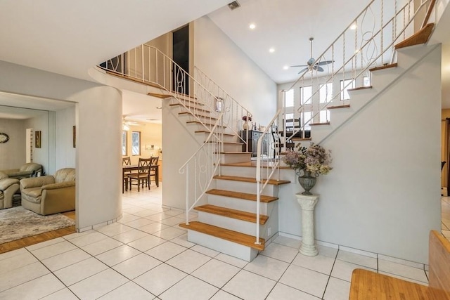 stairs with tile patterned flooring and ceiling fan