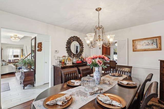 dining area featuring hardwood / wood-style flooring and a notable chandelier