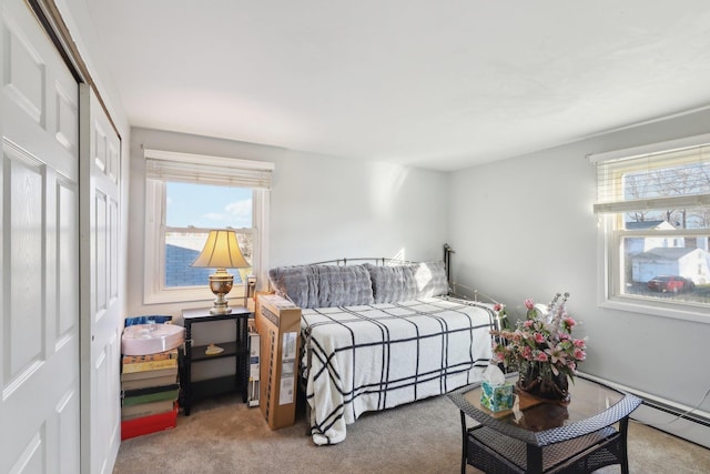 carpeted bedroom featuring a closet and baseboard heating