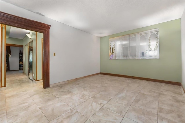 spare room with a textured ceiling