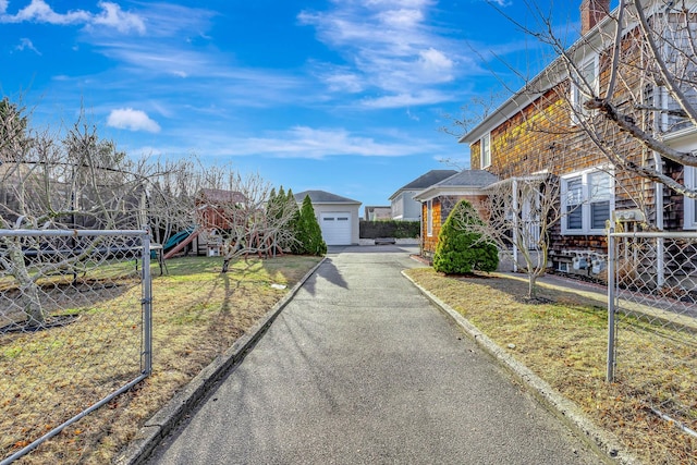 view of side of home with a playground, a garage, and a yard