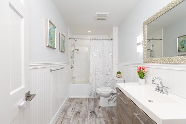 full bathroom with shower / bathtub combination with curtain, vanity, hardwood / wood-style flooring, and toilet