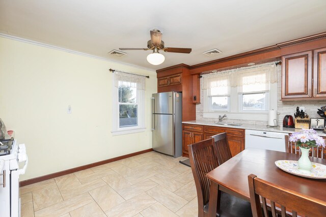 kitchen with sink, decorative backsplash, ceiling fan, crown molding, and white appliances