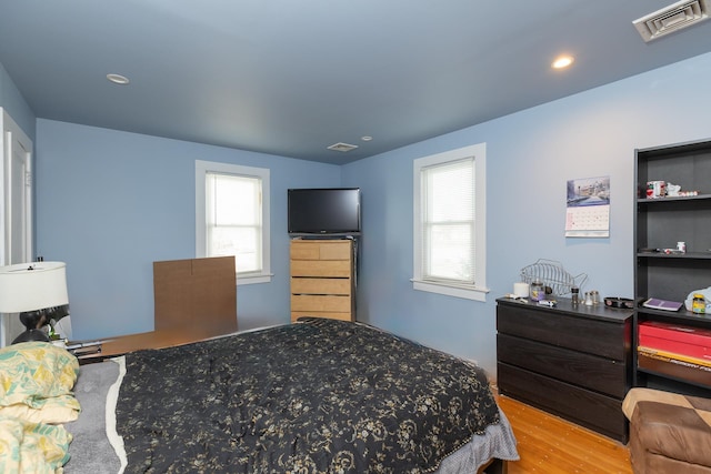 bedroom with hardwood / wood-style flooring