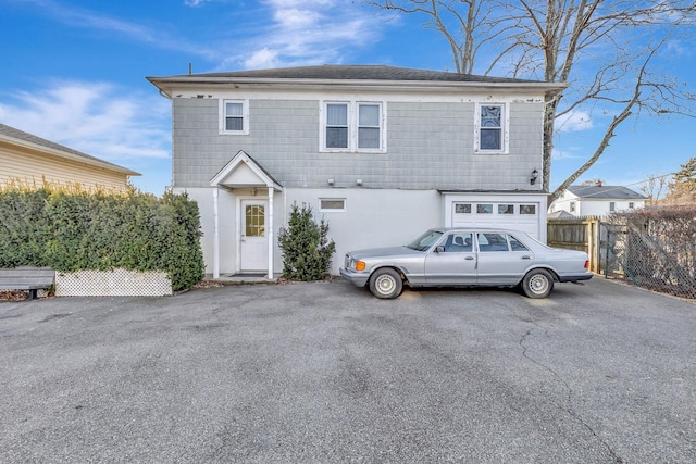 back of house featuring a garage