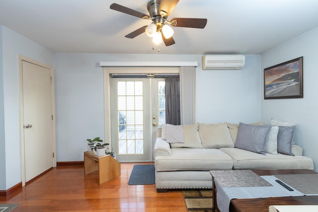 living room with hardwood / wood-style flooring, a wall mounted AC, ceiling fan, and french doors