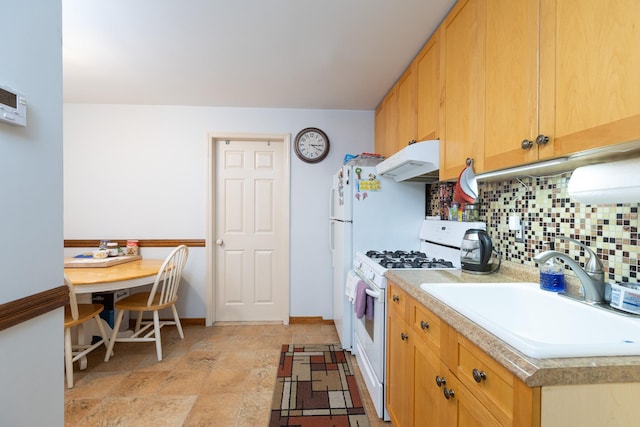 kitchen featuring decorative backsplash, sink, and gas range gas stove