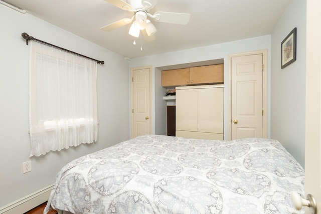 bedroom featuring a baseboard radiator, a closet, and ceiling fan