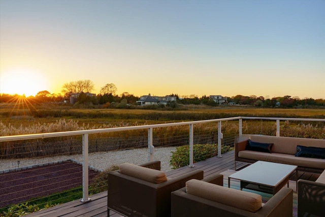 deck at dusk with outdoor lounge area