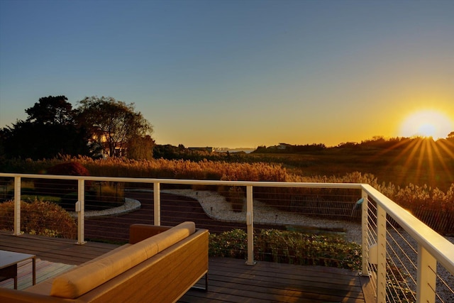 deck at dusk featuring an outdoor hangout area