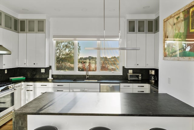 kitchen with appliances with stainless steel finishes, decorative light fixtures, sink, and white cabinets