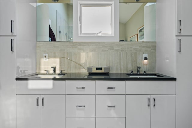 bathroom featuring vanity and decorative backsplash