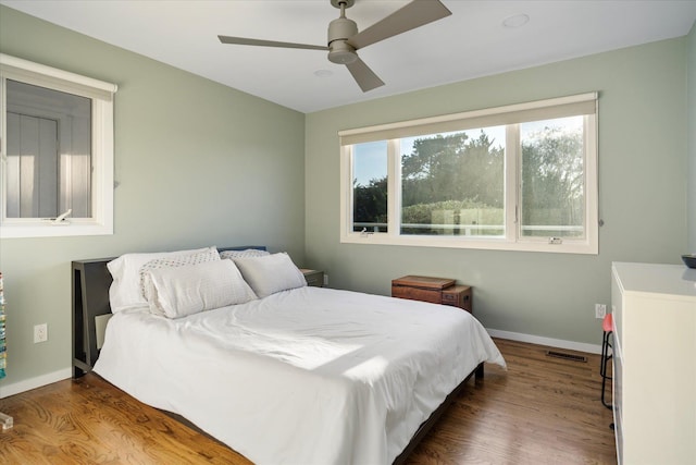 bedroom with hardwood / wood-style floors and ceiling fan