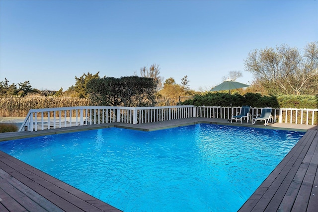 view of swimming pool with a deck