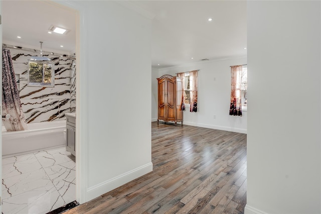 interior space with ornamental molding, recessed lighting, light wood-style flooring, and baseboards