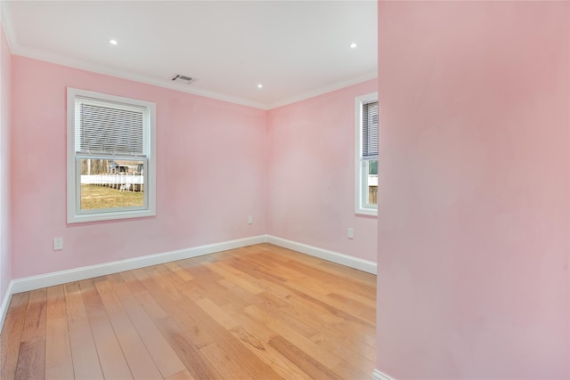 unfurnished room featuring visible vents, baseboards, ornamental molding, light wood-type flooring, and recessed lighting