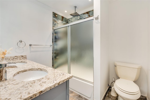 full bathroom featuring toilet, vanity, and bath / shower combo with glass door