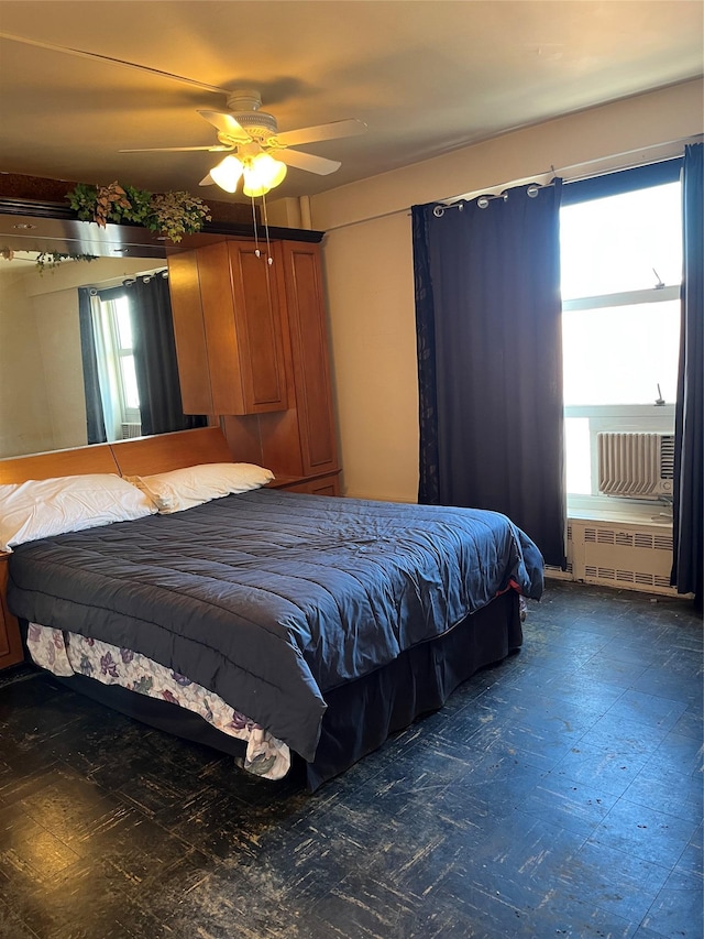 unfurnished bedroom featuring ceiling fan and radiator heating unit