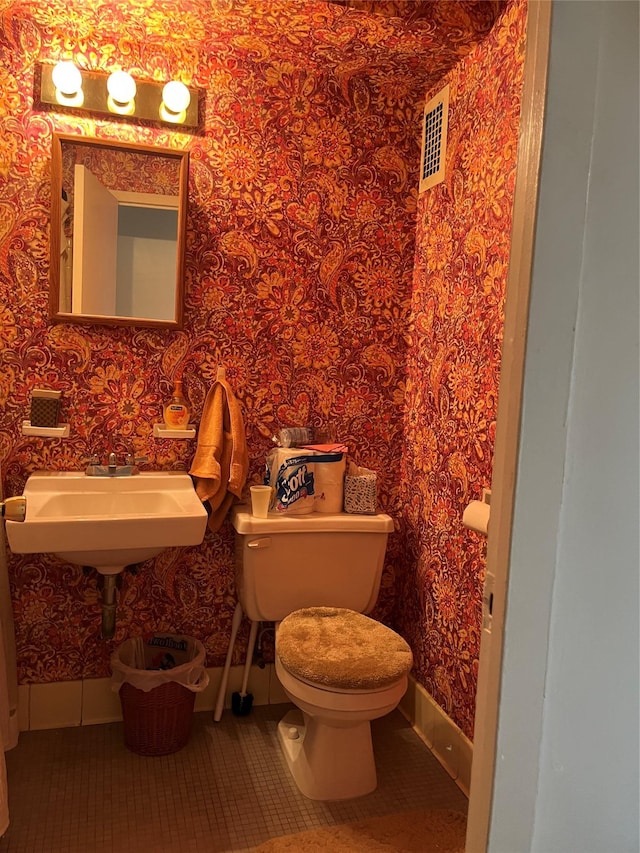 bathroom with tile patterned flooring and toilet