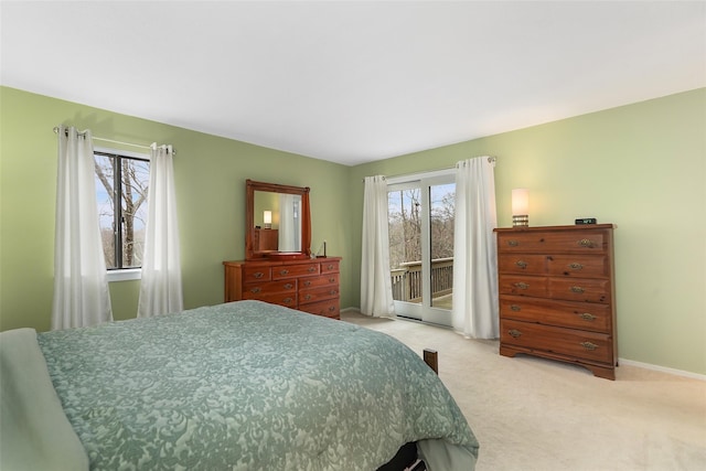 bedroom featuring access to exterior, light colored carpet, and baseboards