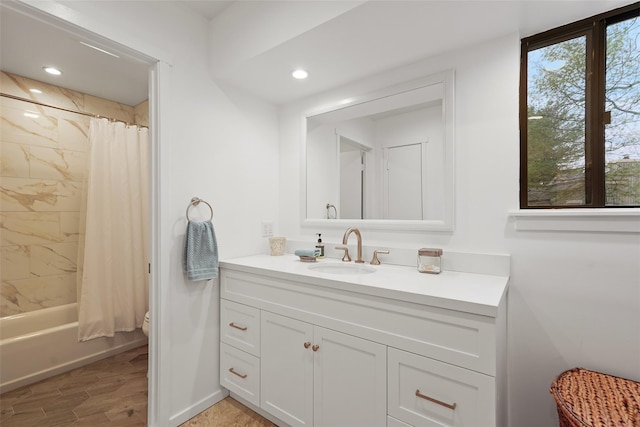 full bathroom featuring a wealth of natural light, vanity, toilet, and wood finished floors