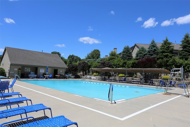 community pool featuring a patio area and fence