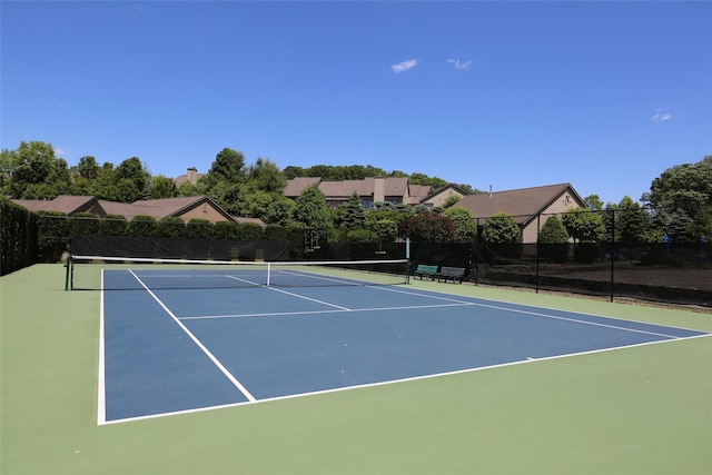 view of sport court featuring fence