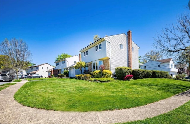 view of home's exterior featuring a residential view, a chimney, and a yard