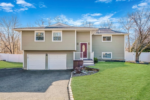 split foyer home with a garage and a front yard