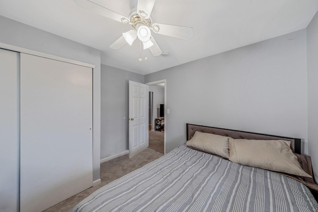 unfurnished bedroom with light carpet, a closet, and ceiling fan