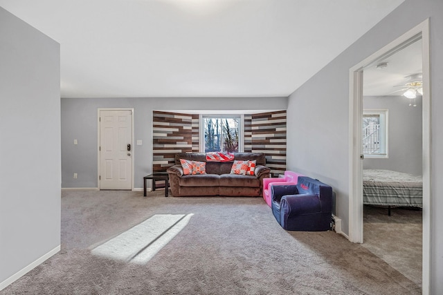 living room with light colored carpet and ceiling fan