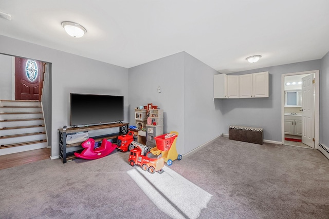 recreation room featuring light carpet and sink