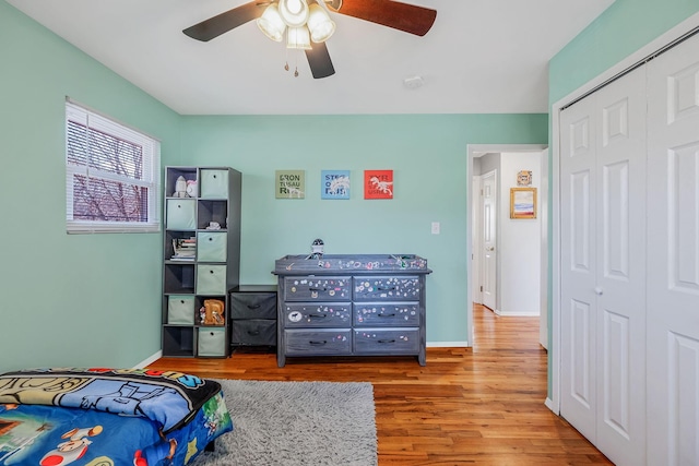 bedroom featuring wood-type flooring, ceiling fan, and a closet