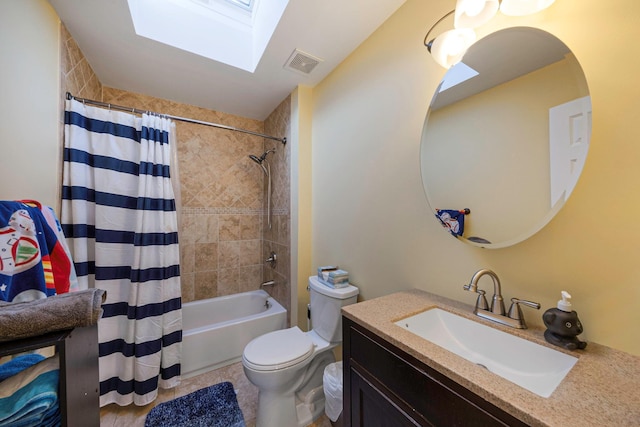 full bathroom featuring a skylight, vanity, shower / bathtub combination with curtain, and toilet