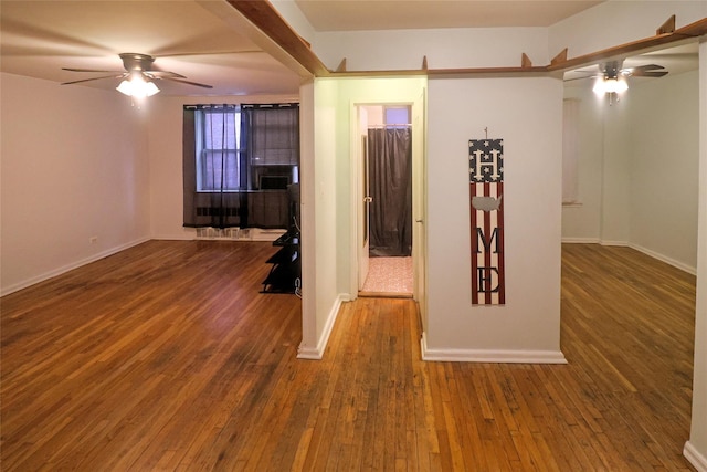 spare room featuring dark wood-type flooring and ceiling fan