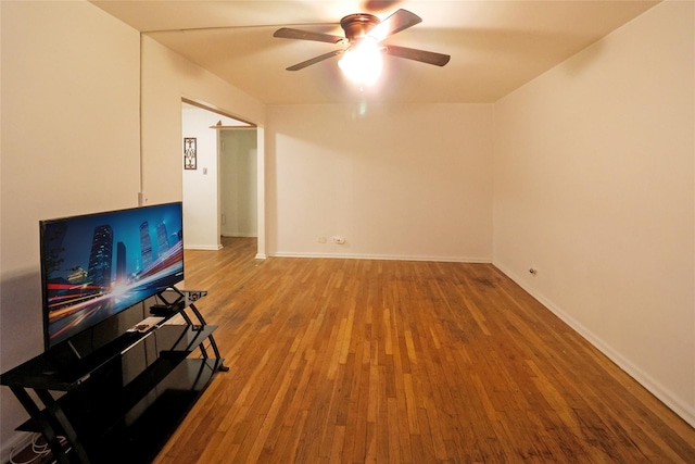 unfurnished living room with wood-type flooring and ceiling fan