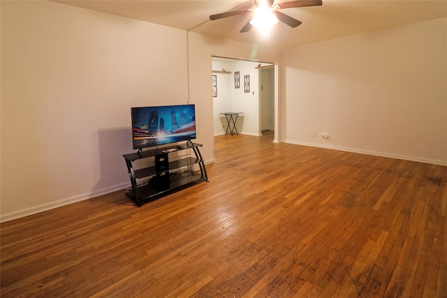 living room featuring wood-type flooring and ceiling fan