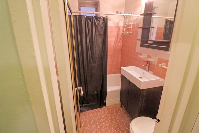 full bathroom with sink, tile walls, shower / bath combo with shower curtain, and toilet