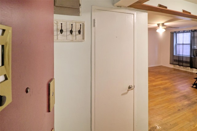 corridor with light hardwood / wood-style floors