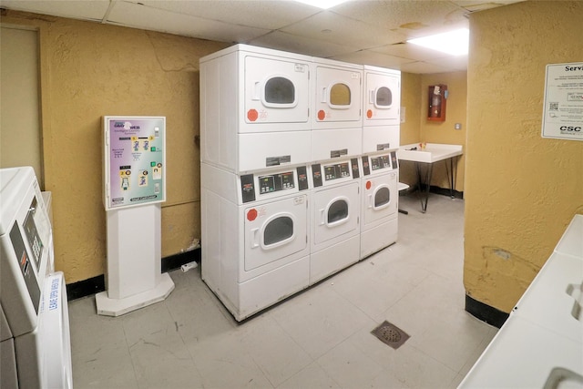 clothes washing area featuring stacked washer / drying machine and washing machine and dryer