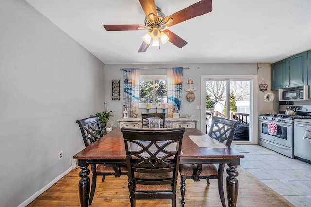 dining room featuring ceiling fan, a healthy amount of sunlight, and light wood-type flooring