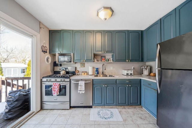 kitchen featuring stainless steel appliances, light tile patterned flooring, and sink